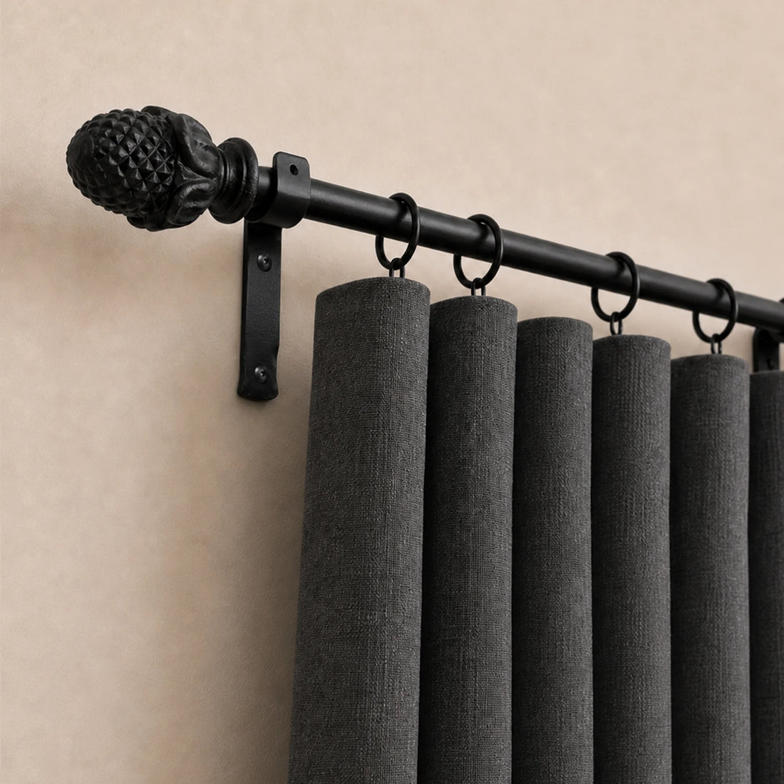 Wrought iron curtain pole with decorative finials in matt black