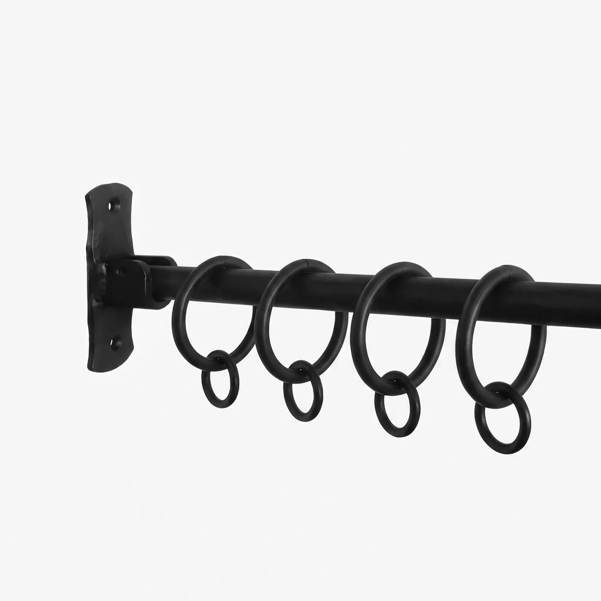 Wrought iron curtain rings added to a curtain pole