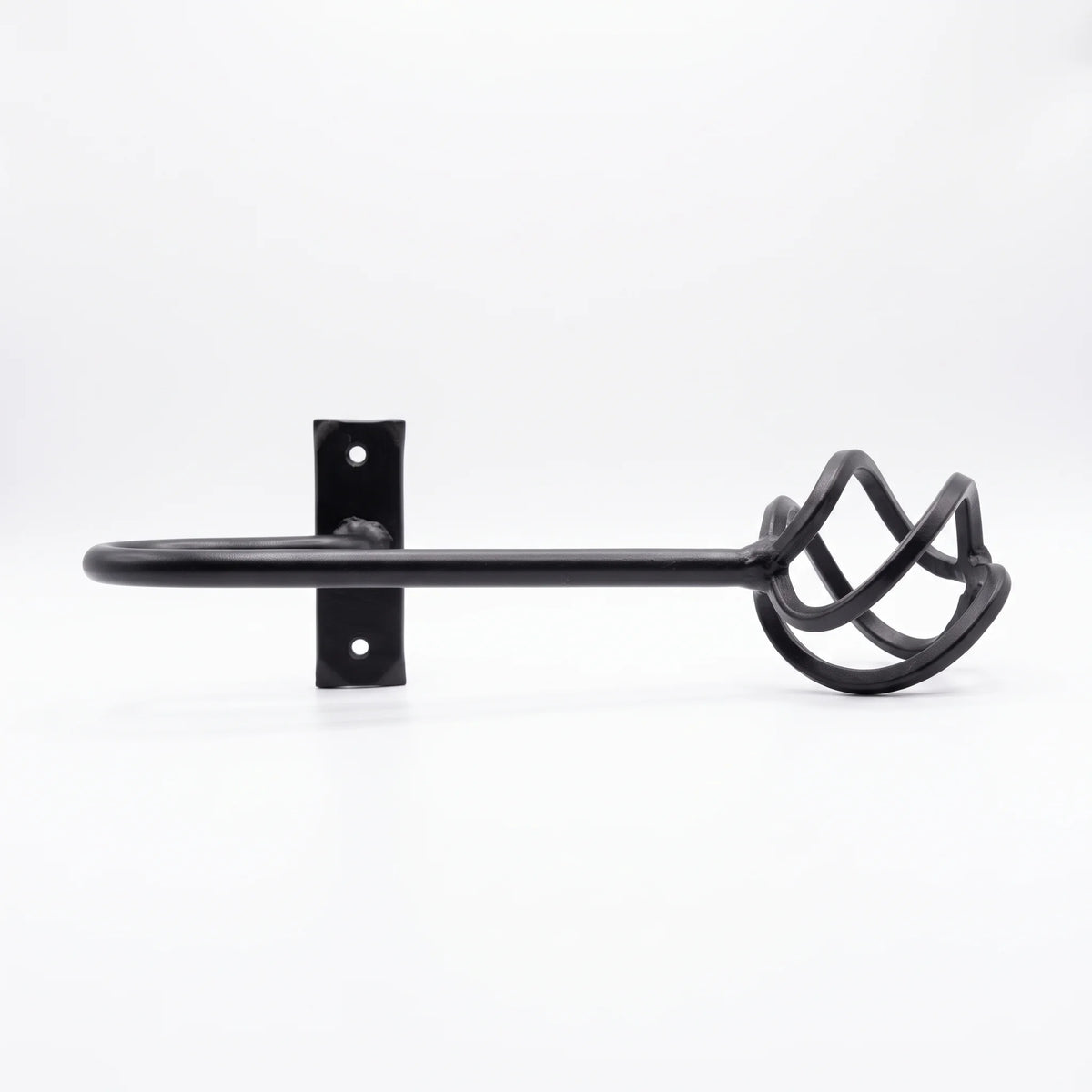 Black wrought iron curtain pole with decorative scroll finial