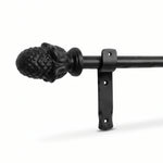 Black wrought iron curtain pole with decorative finial and mounting bracket