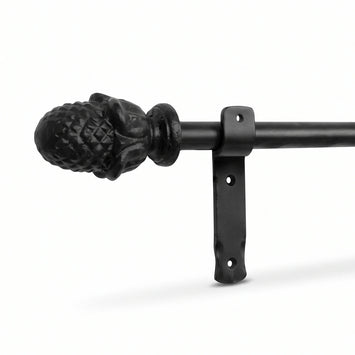 Black wrought iron curtain pole with decorative finial and mounting bracket