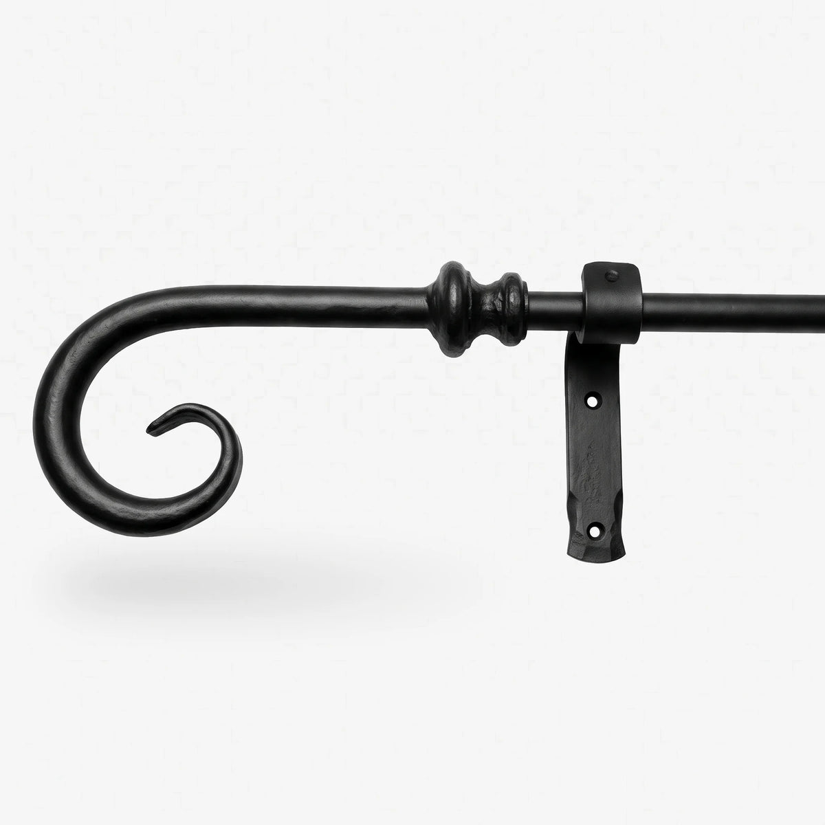 Wrought iron curtain rings being removed from a curtain pole