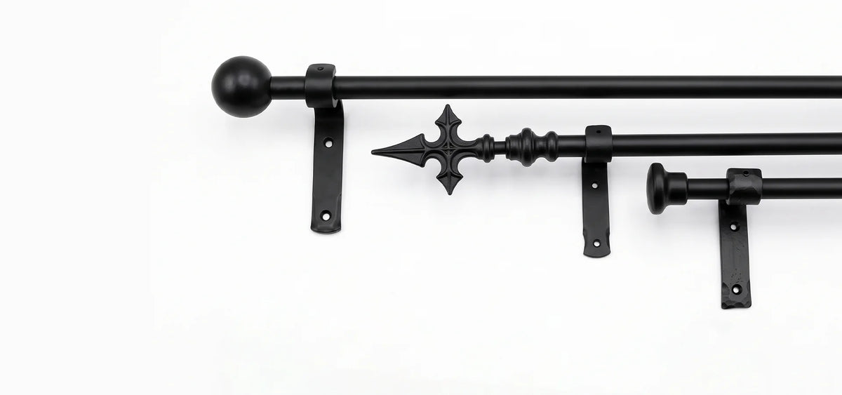 Black metal curtain rod hardware set with ball finials, decorative spear finial, and mounting brackets on a plain white background.